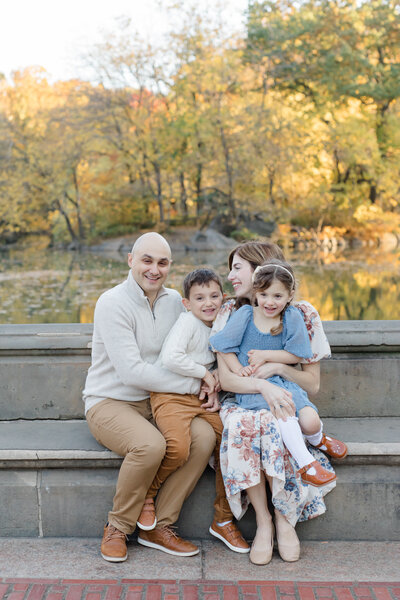 Family of four outdoors in the fall in NYC for family photos