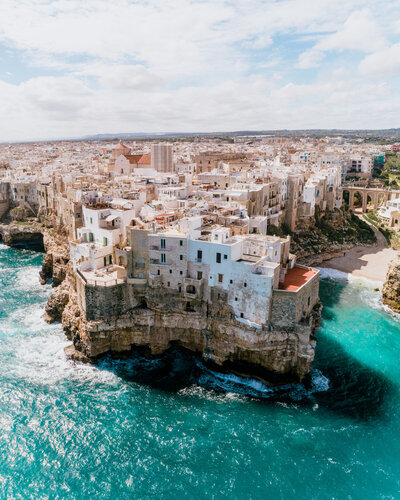 buildings on cliff next to ocean