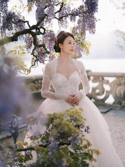 Bridal portrait in wisteria during a villa del Balbianello wedding, by luxury destination wedding photographer Andreas K. Georgiou  