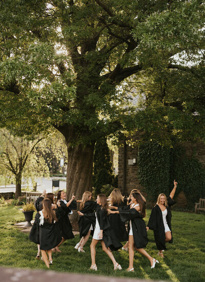 Group of college graduates posing together and celebrating their achievement during a graduation photoshoot in New York City