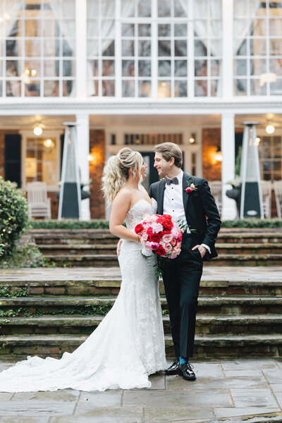 E Stokes Creations bride and groom, standing outside of the Estate in Atlanta, before their New Year's Eve wedding.