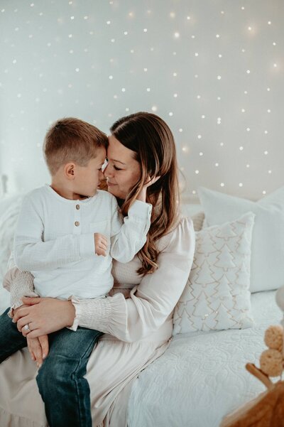 Family sitting in the Christmas setup at Evermore Place for a holiday card session in Gray, Maine.