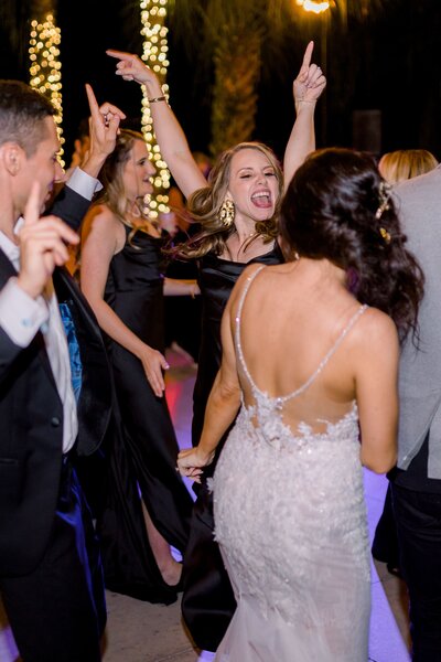 Bride and guests dancing during reception