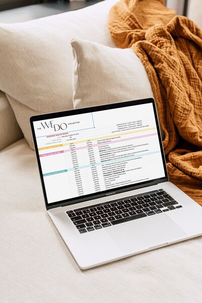Mockup image of a laptop on a couch with an orange blanket in the background. On the laptop screen, is the run of show timeline spreadsheet