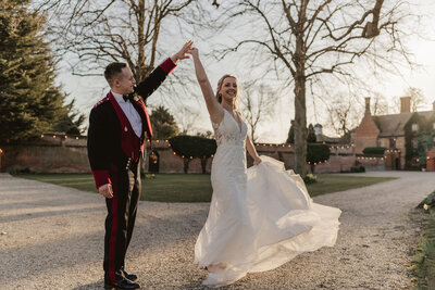 bride and groom dancing in the sunset outside woodhall venue