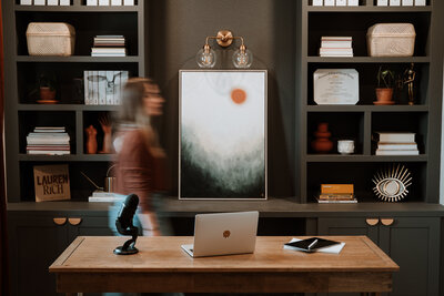 Blurred woman walking in her curated design office, indoor branding portrait taken in Colorado