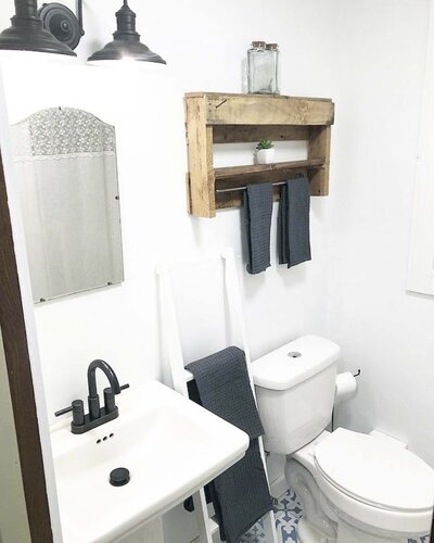 white renovated bathroom with a towel ladder