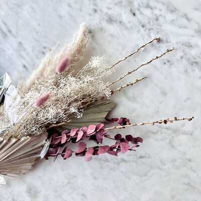 Bundle of dried flowers on a marble table