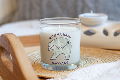 Momma Bear Massage Logo  a bear with marbling displayed on  a Candle