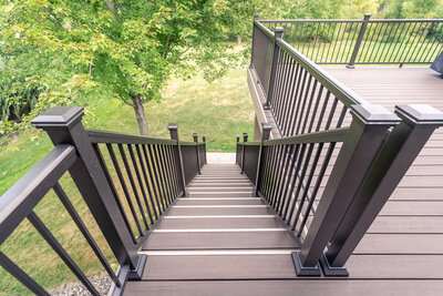 Top view of a deck staircase using TimberTech Impressions aluminum railing in black with picket infill. 