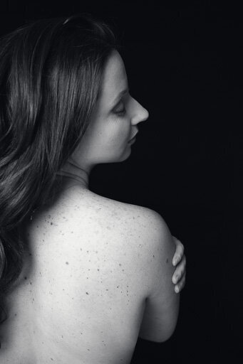 Back portrait of a lady with long dark hair.