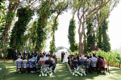 View from down the aisle of a couple during their wedding ceremony 