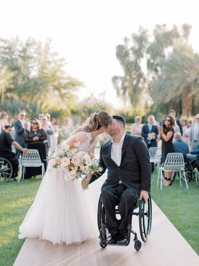 Photographer, Tiffany Gentry, kisses her husband on their wedding day