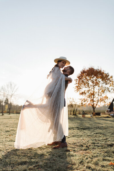Modern Farm wedding with couple laughing during golden hour