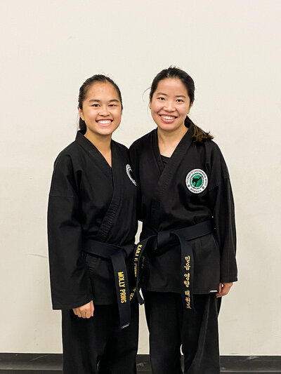 two girls smiling doing taekwondo
