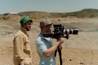 two men filming in nature