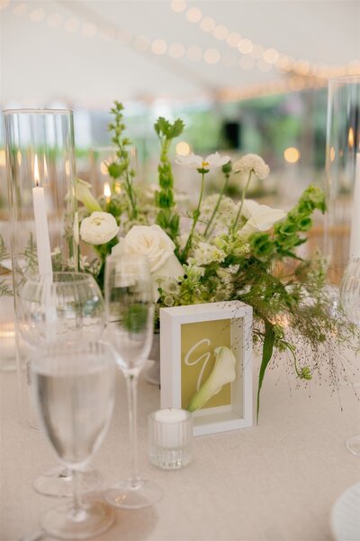 Chartreuse table number with white numeral in a shadow box with white calla lily for wedding at Lion Rock Farm in Litchfield County, Connecticut.