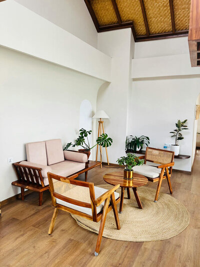 Photo of a modern interior living room with chairs, a coffee table, and plants