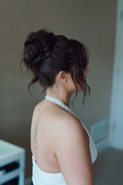 Bride with a trendy high bun and sleek edges — bold yet elegant bridal hairstyle by Klover Beauty, perfect for fashion-forward Maryland weddings.