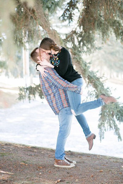 Idaho wedding photographer captures outdoor wedding with man lifting woman