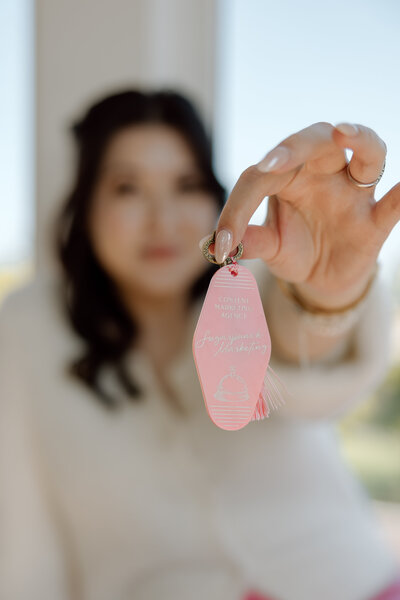 Sugarpunch Marketing® founder Shanté Gorman holding a pink key tag with 'Content Marketing Agency, Sugarpunch Marketing®' printed on it.