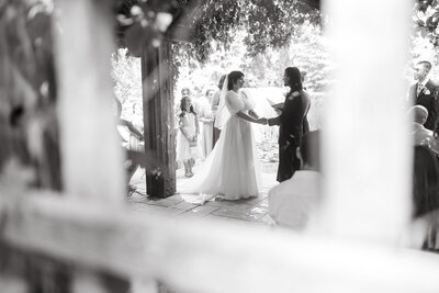 A classic black and white photograph capturing an emotional wedding ceremony moment.