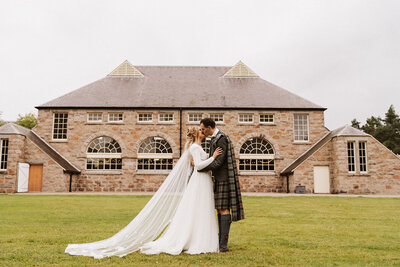 Bride and bridesmaids laughing under confetti at aswanley wedding venue
