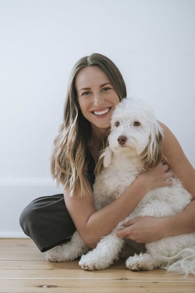 Joyful woman cuddling her dog