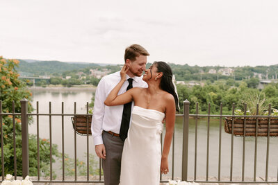A bride and groom pose for portraits at golden hour