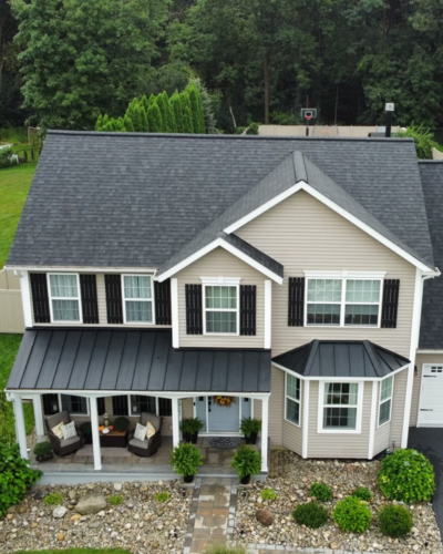 Completed Roof replacement on a residential home with Owens Corning Onyx Black asphalt shingles and black metal roofing