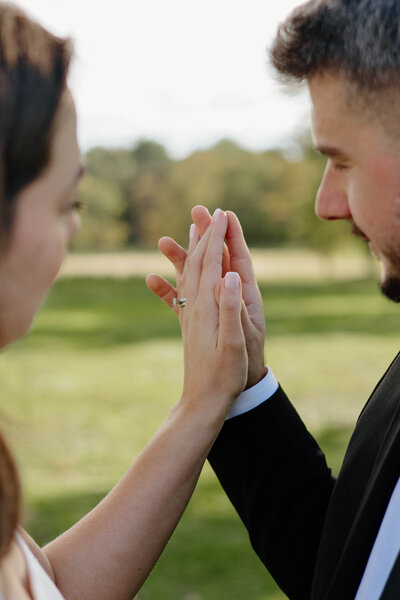 a couple holding their hands together during their engagement session at Waveny Park in New Canaan, CT