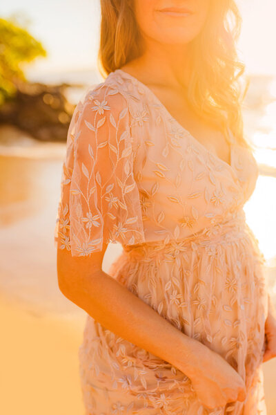little girl looks up at her mom during their photoshoot in oahu with love and water