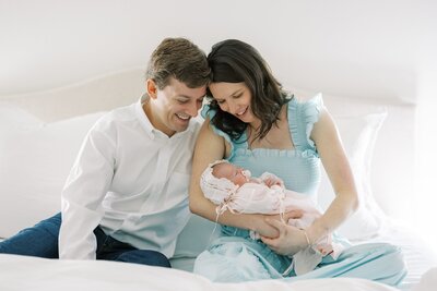 couple holding their baby during their newborn session
