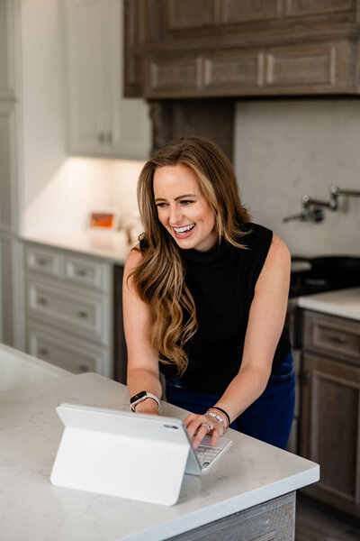 JaCee Petko, Christian life coach, working on her iPad in the kitchen