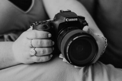 Canon Camers sitting in lap in black and white