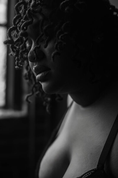 close up of a plus size woman during a boudoir shoot with her hair cascading down her face