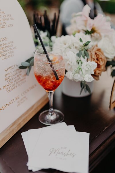 Aperol Spritz on custom napkin at wedding bar