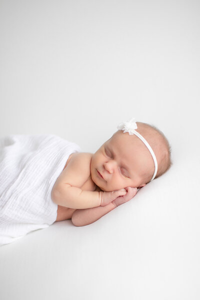 newborn baby with hands under face at Tiffany Hix Photography during pictures in Boise studio