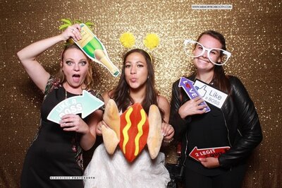 two girls and a bride pose for a photobooth
