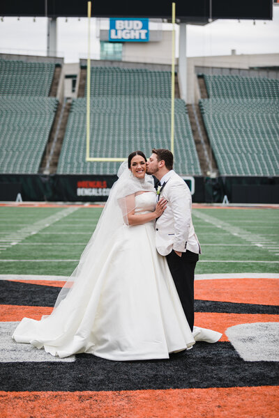 Couple at Paul Brown on The bengals football field on their wedding day