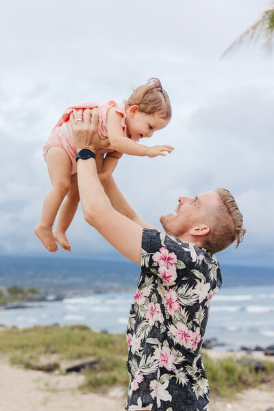 dad tossing daughter in air