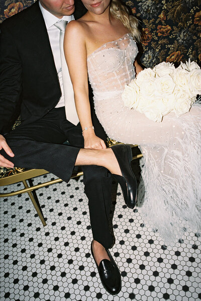 Bride and groom in formal attire with flair at their modern, trendy wedding venue.