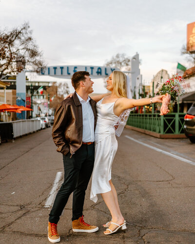 bride and groom dancing in street