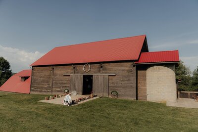 Wide view of a rustic barn with a red roof