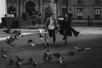 Intimate boudoir photo shoot  Glasgow a couple run through the pigeons holding hands