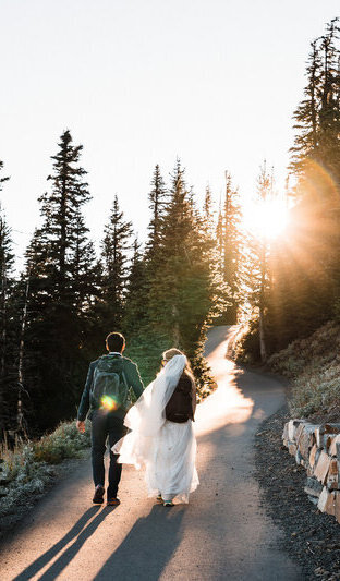 a couple hikes into the sunset on hurricane ridge during their adventure elopement in olympic national park photographed by amy galbraith