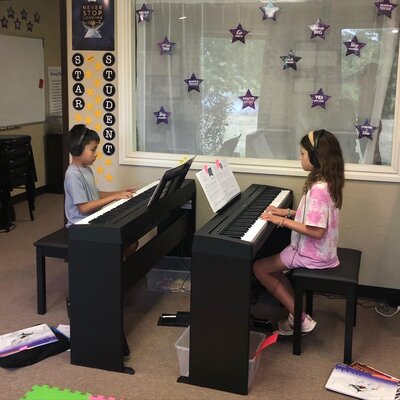 Children playing piano in a piano class in Edmond Oklahoma