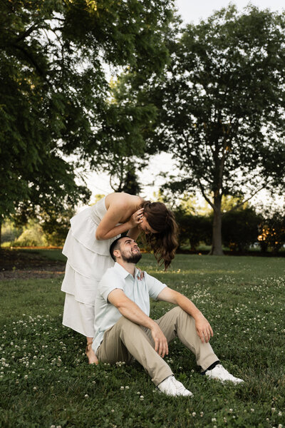 Couple captured in a romantic moment outdoors, surrounded by nature’s beauty, showcasing their love against a serene landscape.