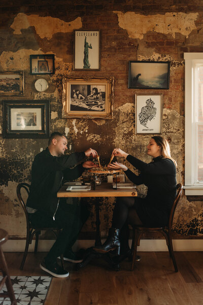 Couple eat pizza at local Cleveland place wearing all black aesthetic