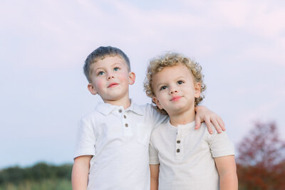 Two little boys staring off into distance for Tampa photographer. Tina Marie Studio.